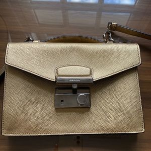 Gold Prada crossbody leather clutch with strap